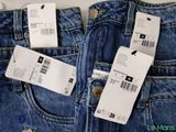 three pairs of levi ' s jeans with price tags on them