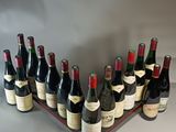 many bottles of wine sitting on a wooden tray