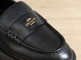 a close up of a pair of black shoes on a table
