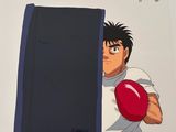 cartoon of a man holding a red ball in front of a wall