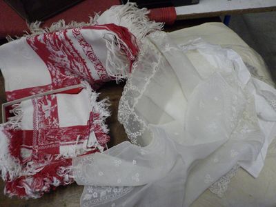 a pile of white and red cloths on a table