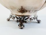 a silver bowl that is sitting on a table