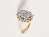 an image of a ring with a blue stone surrounded by white diamonds