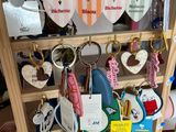 many key chains that are on a wooden shelf