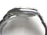 a close up of a watch on a white surface