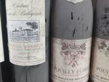 several bottles of wine are lined up on a shelf