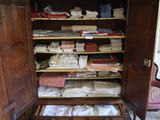 a large wooden cabinet with many items in it