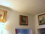 a picture of a living room with paintings on the wall