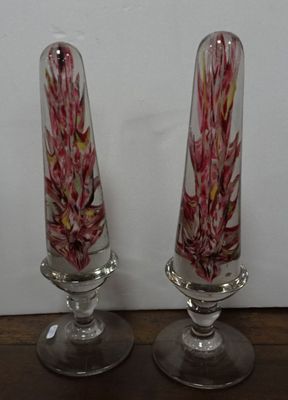 two glass vases that are sitting on a table