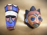two masks that are sitting on a table