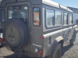 a grey jeep that is parked in a lot