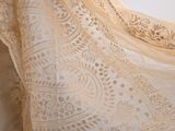 a close up of a dress with a lace pattern on it