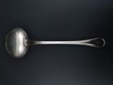 silver spoon on a black surface with a black background