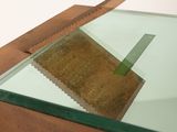 a glass table with a piece of wood on it