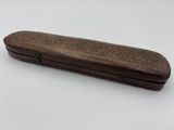 an old wooden case with writing on it sitting on a white surface
