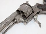 an old gun that is on a white surface