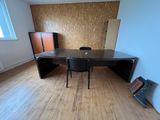 a table and chairs in a room with a wooden floor