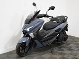 a motorcycle parked in a room with a checkered floor