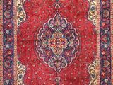 a red rug with a medallion design on it