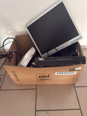 a box with a computer monitor and other electronics in it