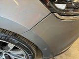 a close up of a car ' s front bumper and tire