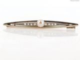 an image of a pearl and diamond hair clip on a white surface