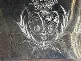 a silver plate with a picture of an owl on it