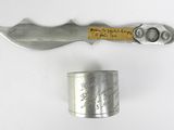 a knife and a canister on a white surface