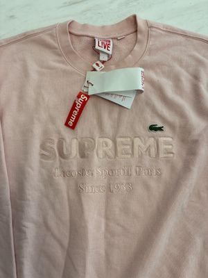 supreme supreme sweatshirt in pink with a tag on it