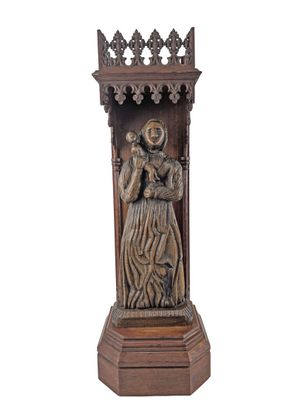 an image of a wooden statue of a woman holding a child