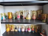 a shelf that has a lot of disney figurines on it