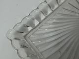 a white glass bowl with a decorative design on it