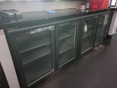 a black counter top with glass doors in a kitchen
