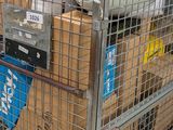 a metal cart with many boxes of items in it