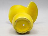 a yellow vase that has two pieces of fruit inside of it