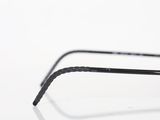 someone is holding a pair of black glasses on a white surface
