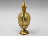 an image of a gold vase sitting on top of a table