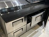 a stainless steel counter top with two drawers underneath it
