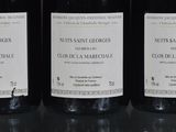 three bottles of wine sitting on top of a table next to each other