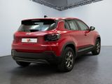 the rear end of a red suv parked in a garage