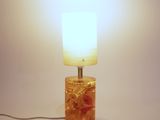 a lamp that is sitting on a table with a light on it