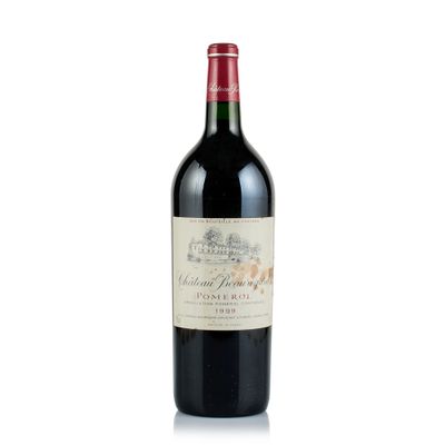 the bottle of red wine is sitting on a white surface