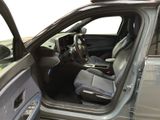 the interior of a car with the door open and the driver ' s seat down