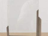 a mirror sitting on a wooden table with a white background