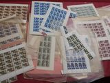 a lot of stamps on a table with a red table cloth