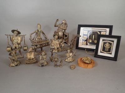a group of silver figurines sitting next to a picture frame