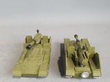 two toy army vehicles that are sitting on a table