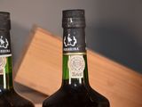 two bottles of wine that are sitting on a table