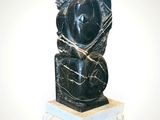 statue of a woman holding a baby in her arms on a marble base