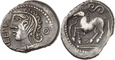 a silver coin with an image of a horse on it
